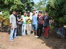 A group of young men posing outdoors in a casual setting.
