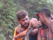 Two men engaged in a close conversation outdoors.